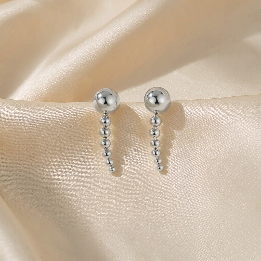 Comet Drop Earrings — Silver — studio view