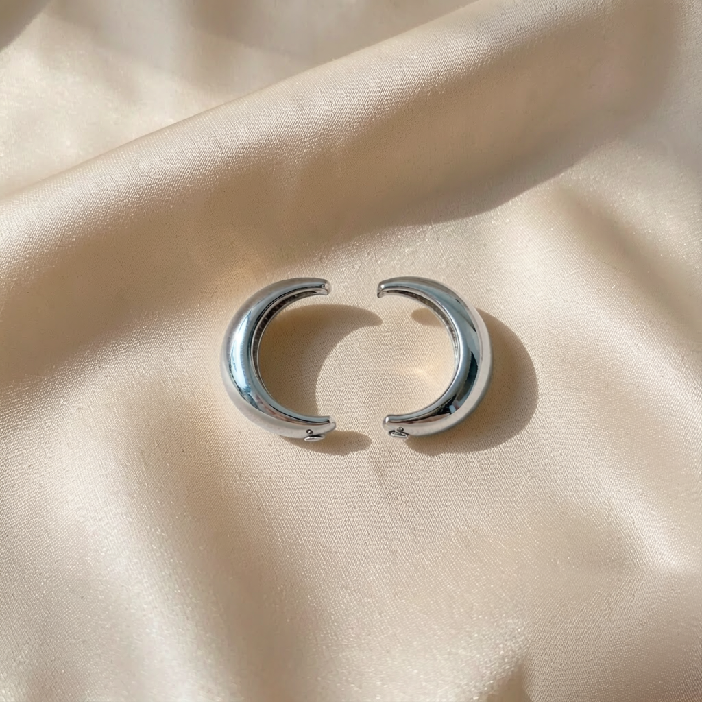 Crescent Hoop Earrings — Silver — studio view